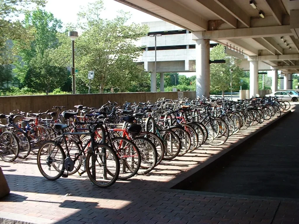 Several cycles parked at bicycle Parking lot.