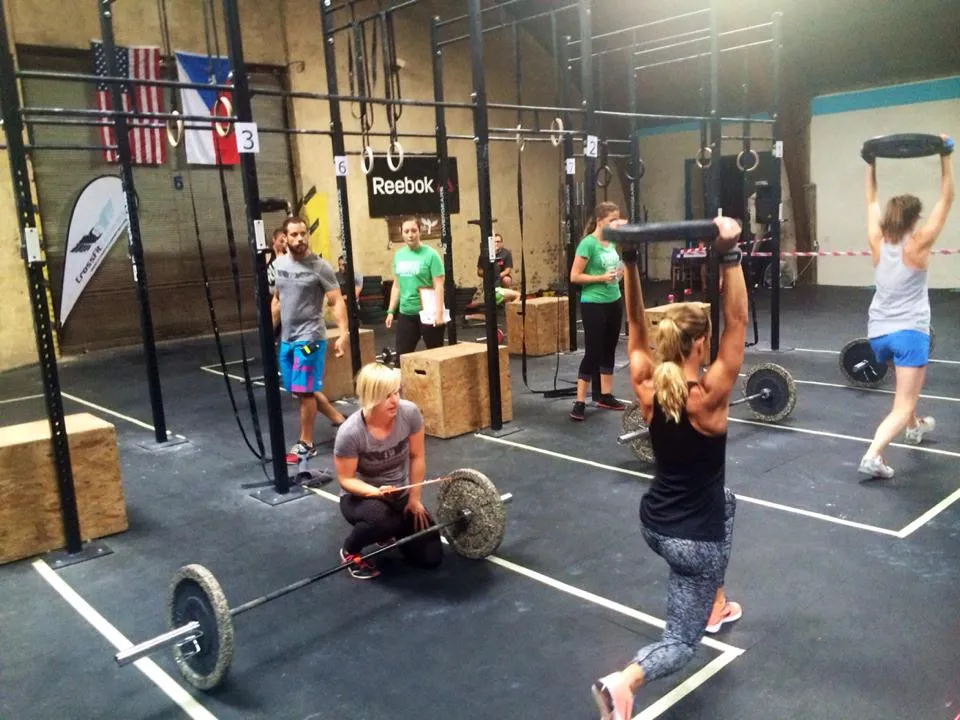 Few People training at an cross fit gym.