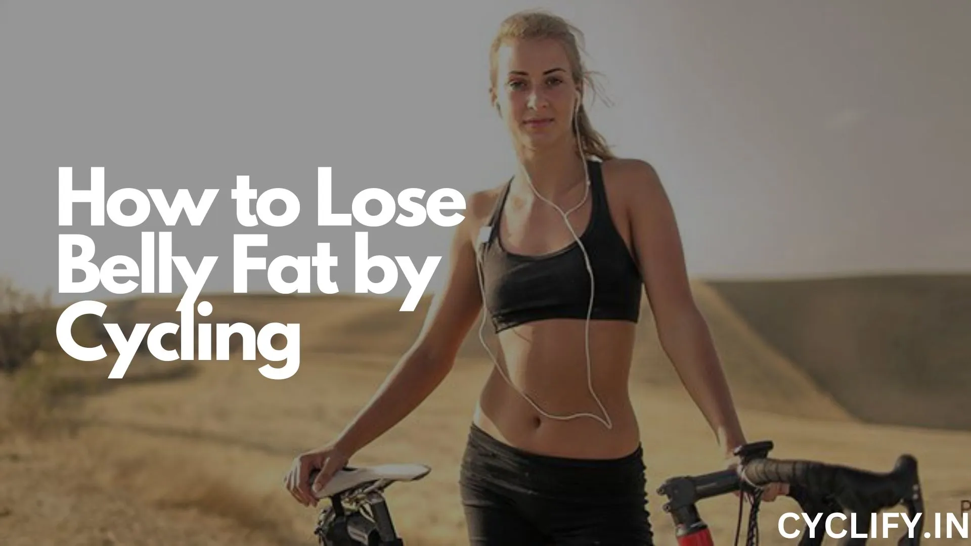 How to lose belly fat by cycling - a lady cyclist standing next to her red gravel bike in a desert like terrain.