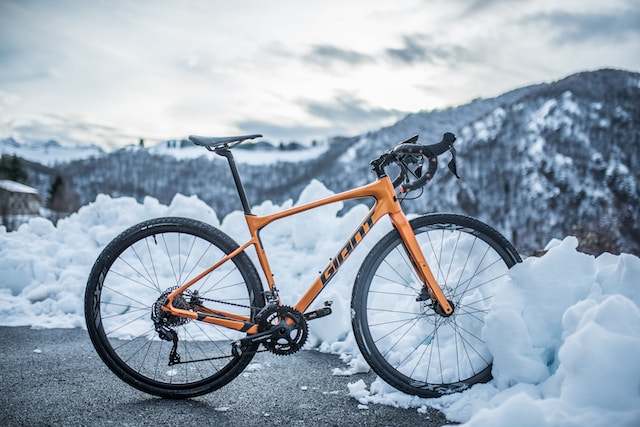 A giant bicycle parked in the snowy mountains