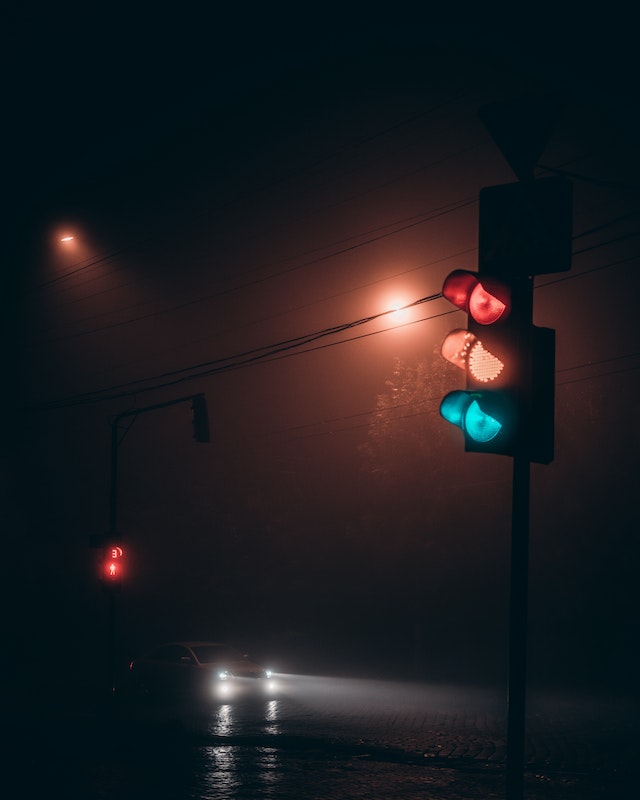 traffic light photo clicked on a rainy night.