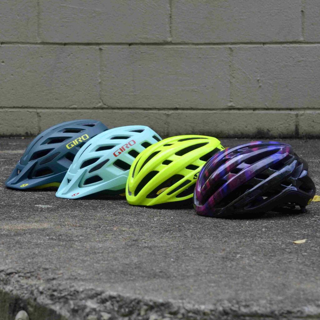 4 Bicycle Helmets next to each other.