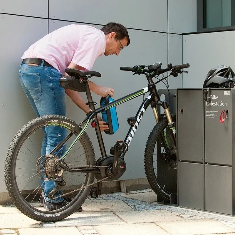 A person Replacing the Battery in His E-bike.