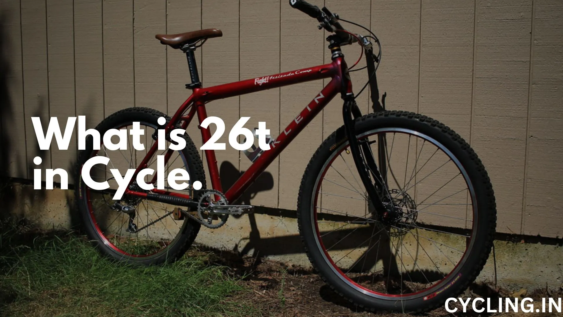 What is 26t in cycle - An Old Red Klein Mountain Bike standing next to a Wall.