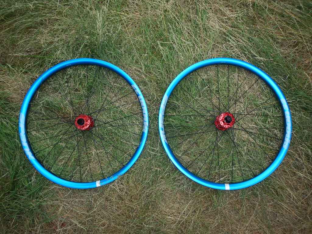 Two 26 inch wheel lying next to each other on the ground.