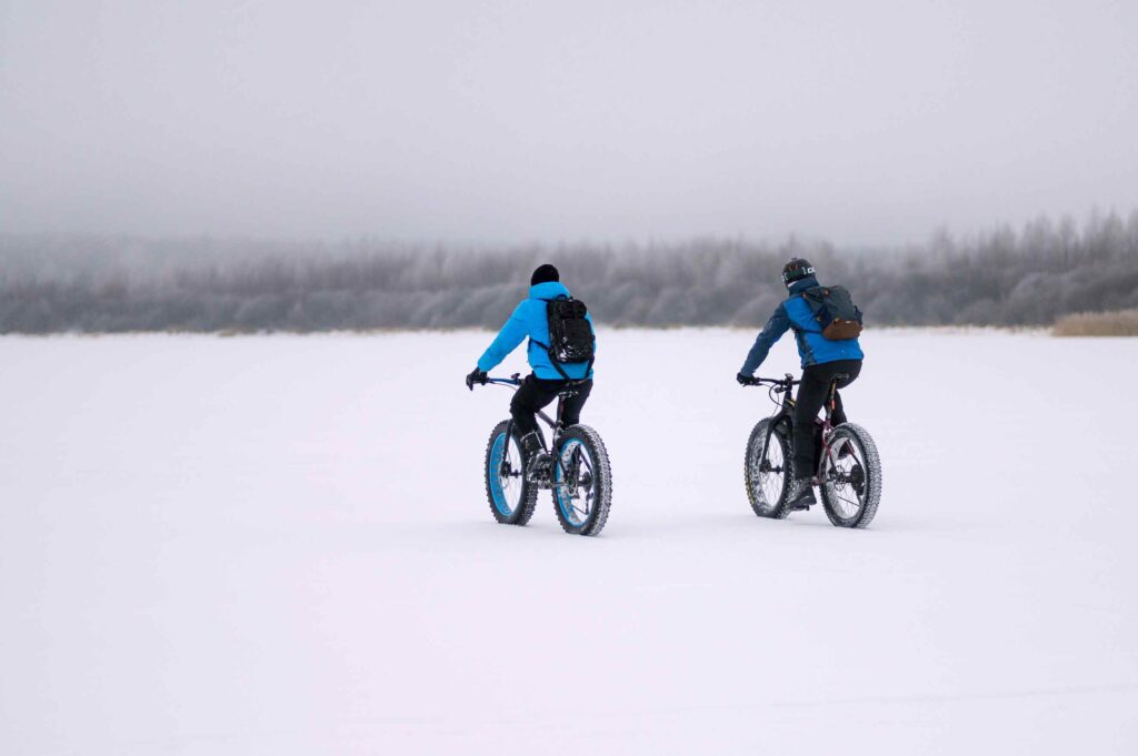 Two people riding in the snow.