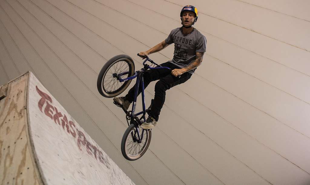 A Cyclist Doing performing on a BMX Bike in a Tournament