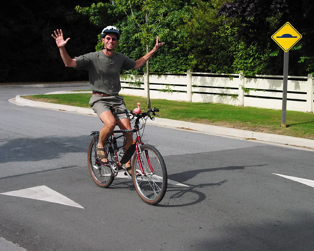 A cyclist riding without using his hands