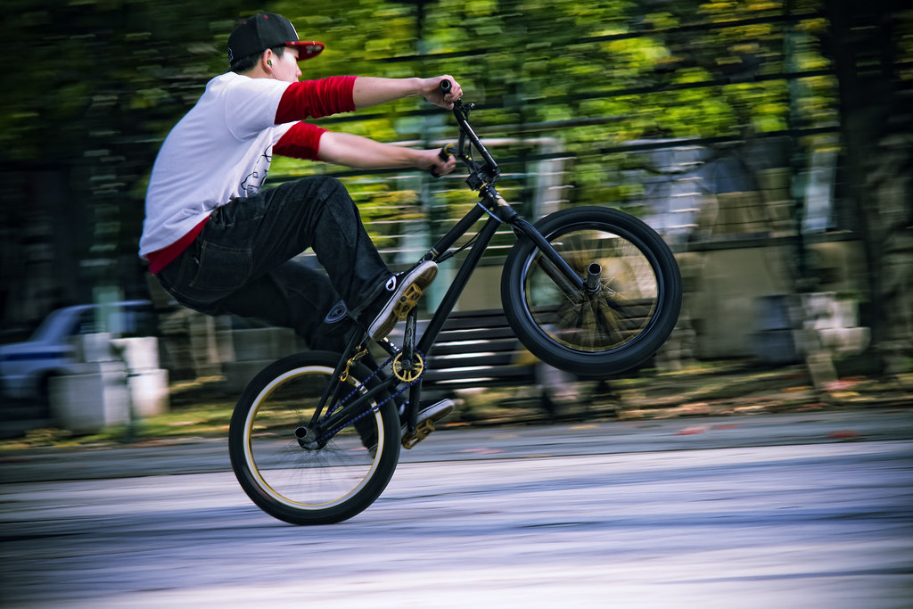A Person performing a Manual on a BMX bike
